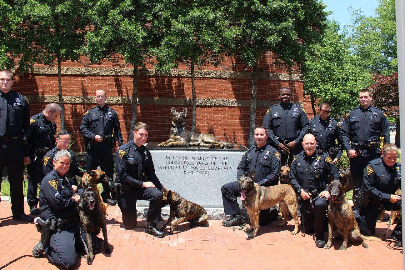 Fayetteville Police officers with K9 memorial statue